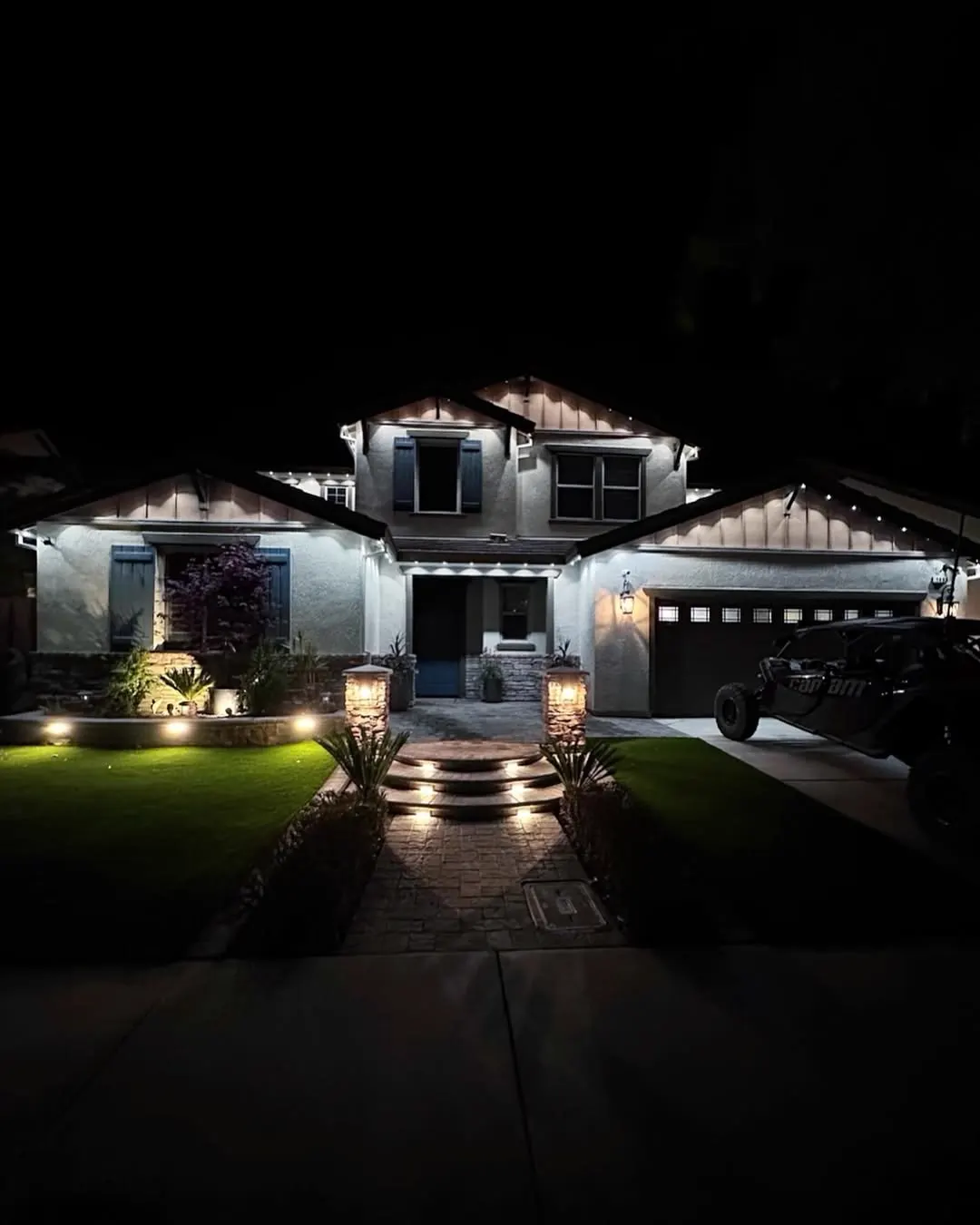 Front of home with subtle warm white permanent lighting