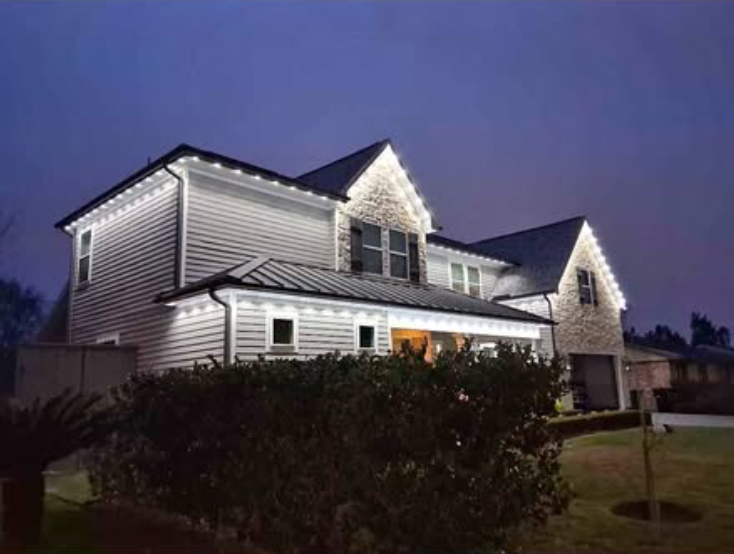 Two-story home with crisp white roofline LEDs at dusk